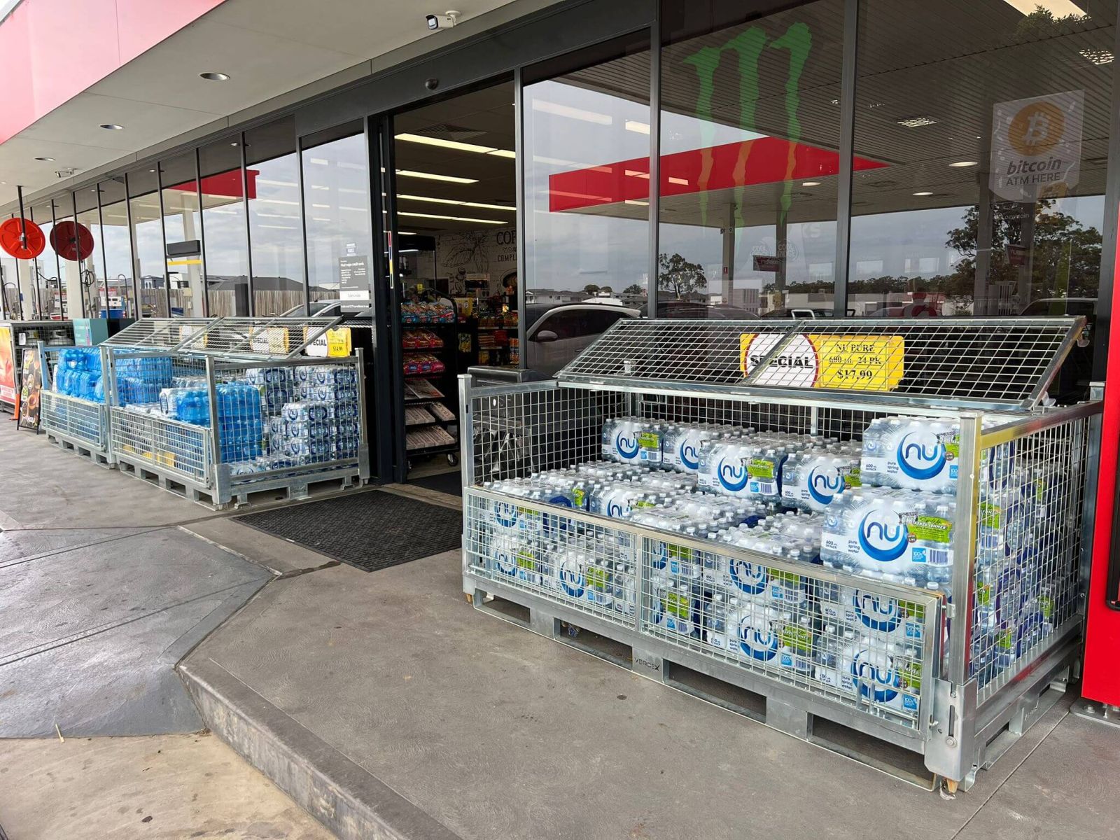 Double Width Storage Cage (Full Height) with bi-fold lid transporting bottled water in retail.