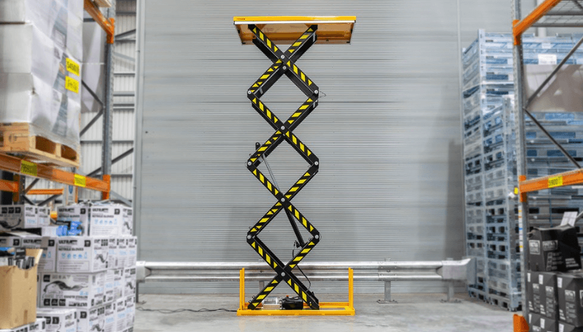 High Lift Scissor Electric Lift Table At Maximum Height In Warehouse