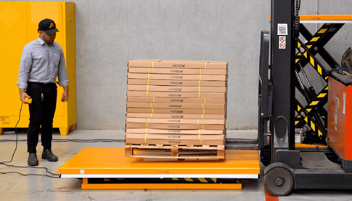 Pallet Of Packaged Goods Placed On Single Scissor Electric Lift Table