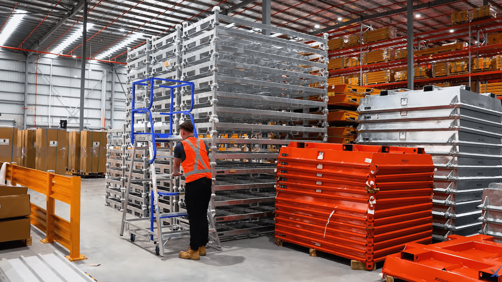 Platform Ladder Positioned Next To Stillage Cages Warehouse