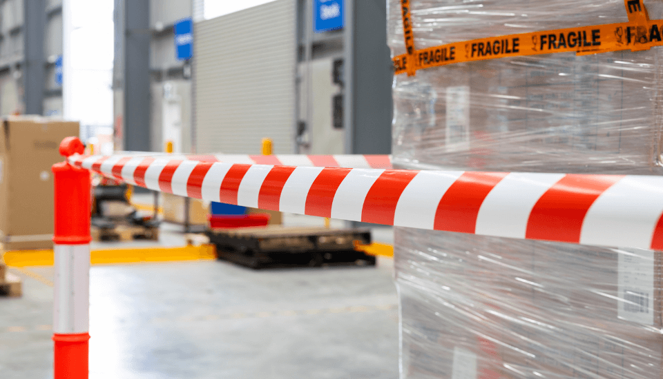 red white barricade tape t top plastic bollards in warehouse