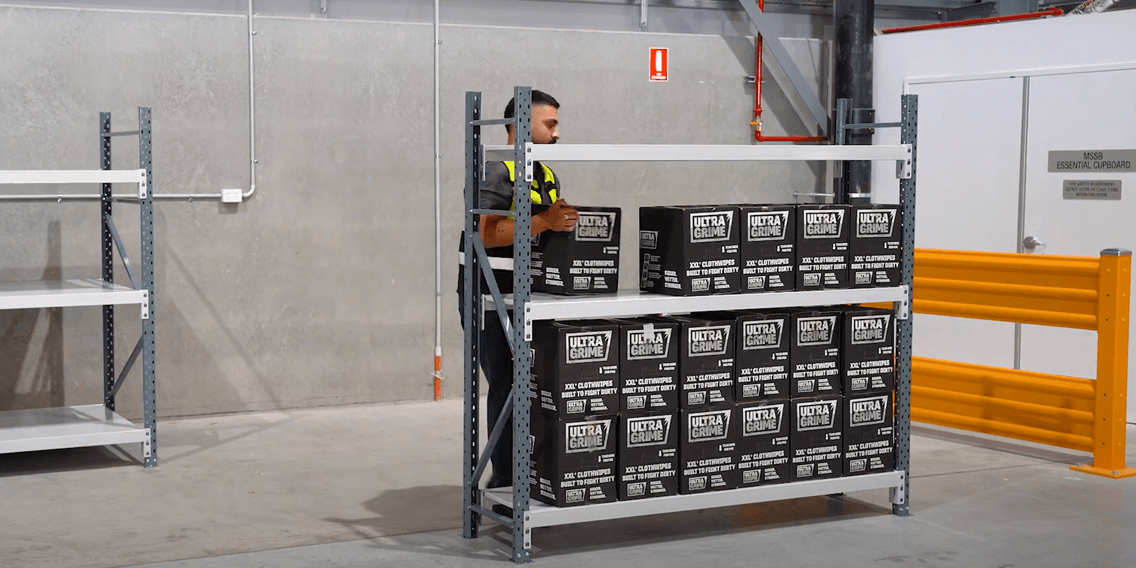 retail specialist employee loading industrial heavy duty mesh longspan shelving ultragrime products.png