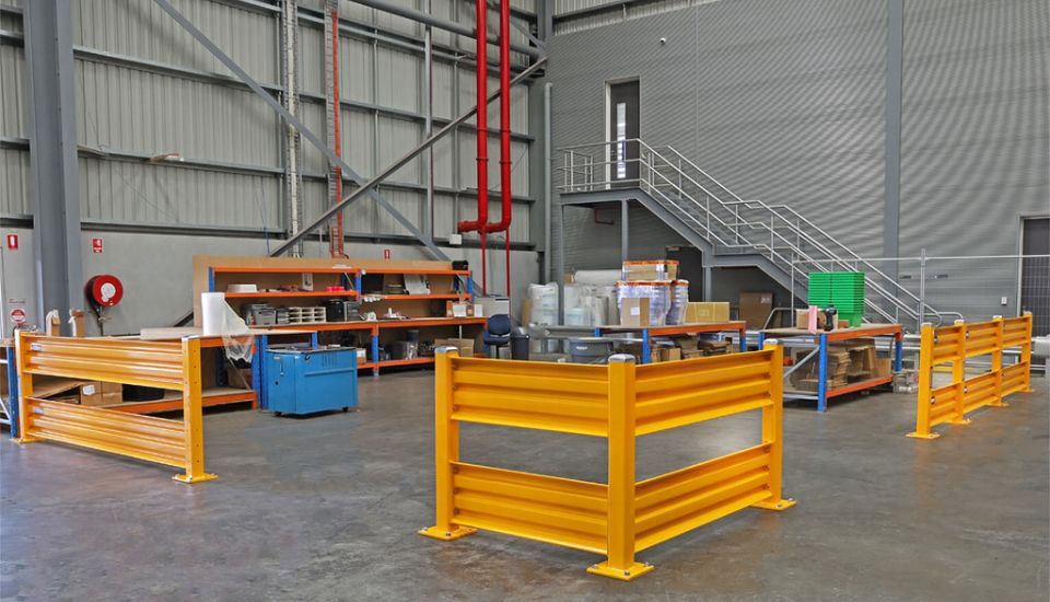 warehouse workstation with yellow safety guard rail fencing barriers