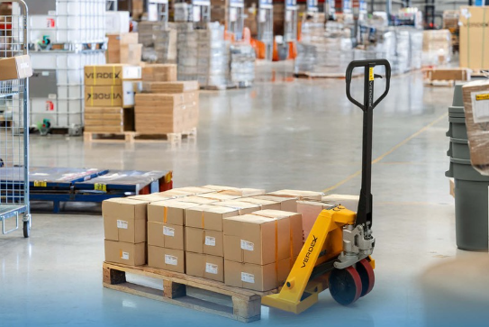 Yellow Verdex Pallet Jack used for moving boxes on a pallet.